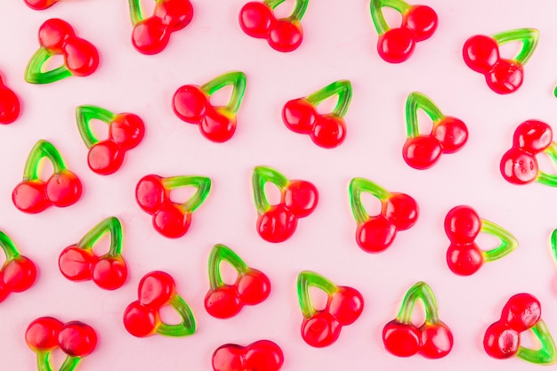 Sweet jelly cherry candies on pink surface