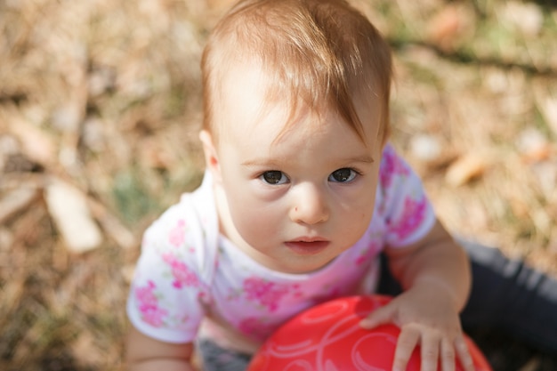 Sweet overweight baby girl looking to camera. Close up portrait of a child. 