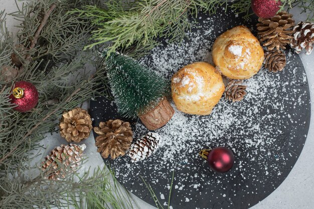 Sweet pastry with pinecones and Christmas tree