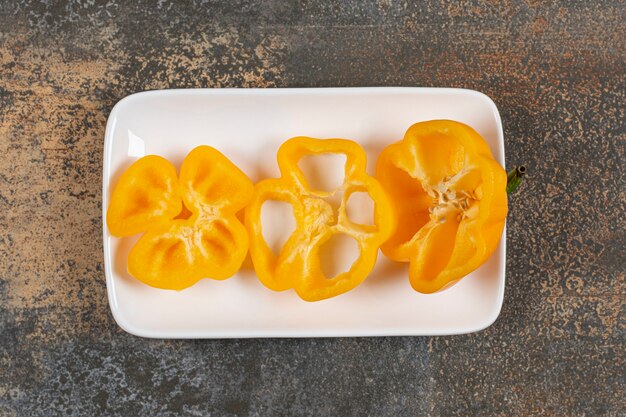 Sweet pepper in the plate  on the marble surface