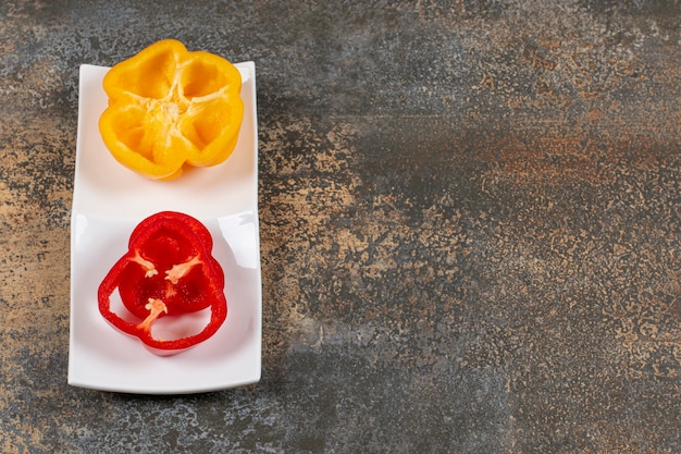 Sweet pepper in the plate  on the marble surface