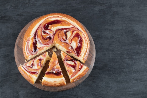 Sweet pie slices isolated on a wooden board.