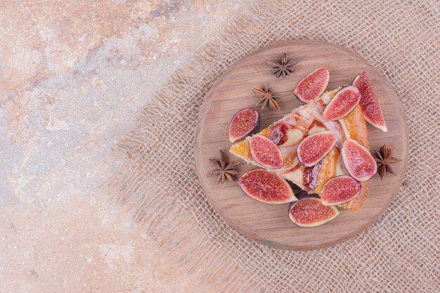 Free photo sweet pie with fig and caramel syrup on a wooden platter.