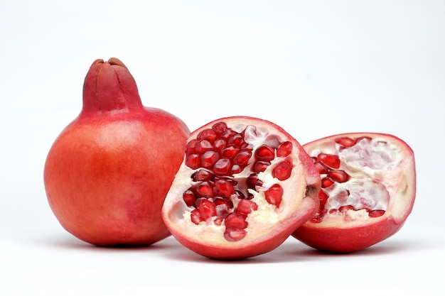 Sweet pomegranates on a white surface