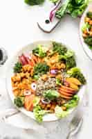 Free photo sweet potato buddha bowl on white table flat lay