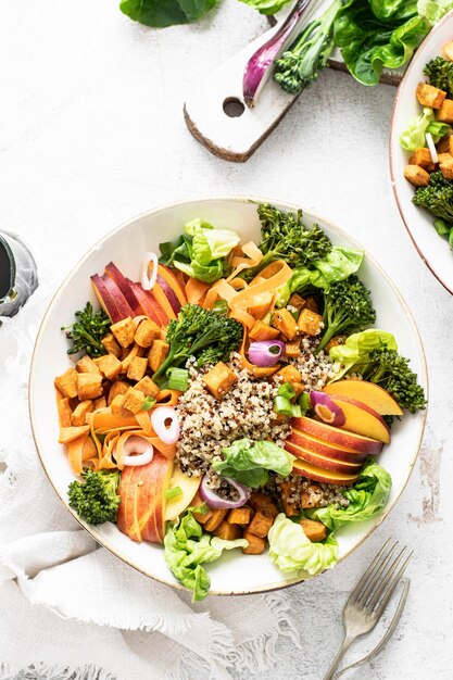 Sweet potato buddha bowl on white table flat lay