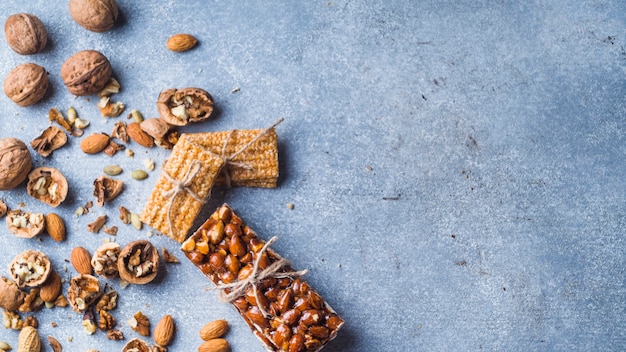 Sweet protein bar with dried fruits on concrete background