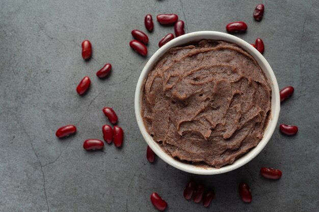 sweet red bean paste in white bowl place on dark floor