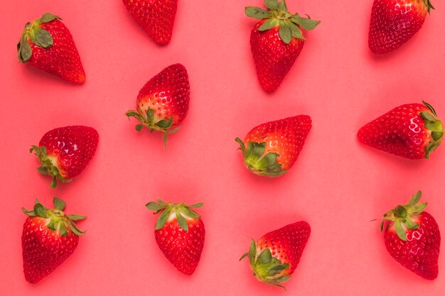 Sweet ripe strawberries on pink background