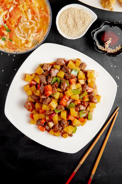  sweet and sour duck with vegetables and pepper on plate