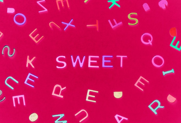 Sweet spelled word with alphabets background