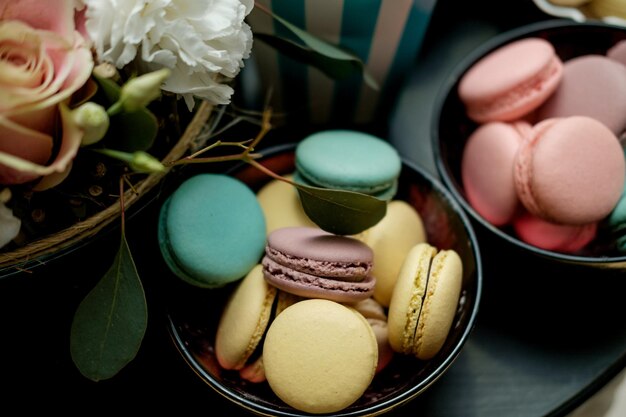 Sweet table at the feast Flowers and multicolored macaroons