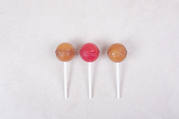 Free photo sweet three lollipops on white background . high quality photo