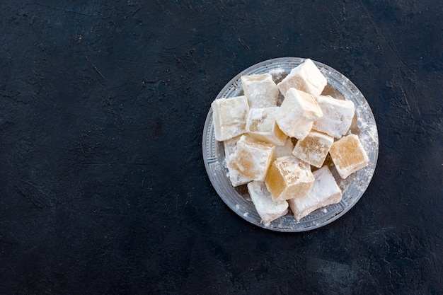 Sweet Turkish delight on black table