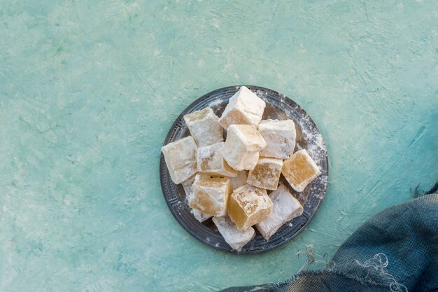 Sweet Turkish delight on blue table