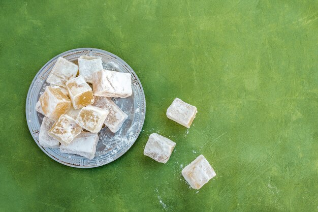 Sweet Turkish delight on plate on table