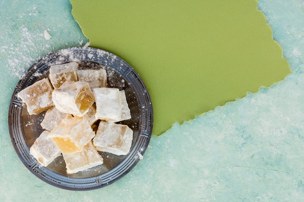 Sweet Turkish delight on plate with blank paper 