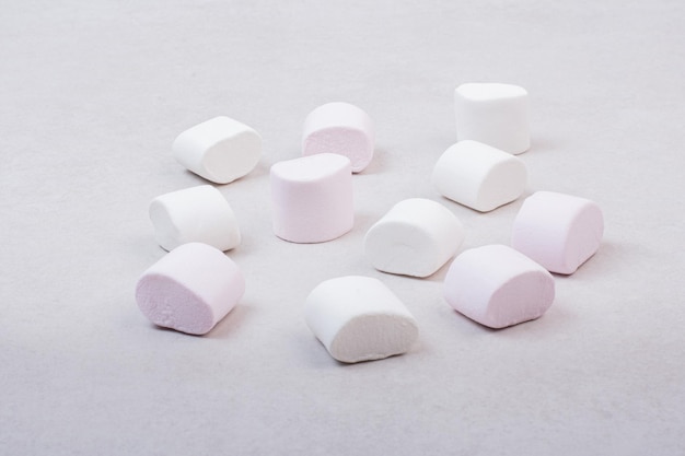 Sweet white marshmallows on white table.