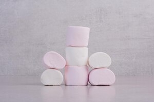 Sweet white marshmallows on white table.