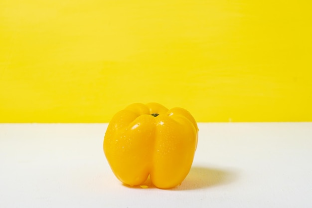 Сладкий желтый перец для здоровья на желтом белом фоне здоровая пища и веганская концепция