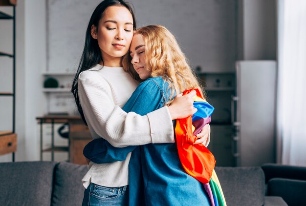 Sweethearts women hugging at home