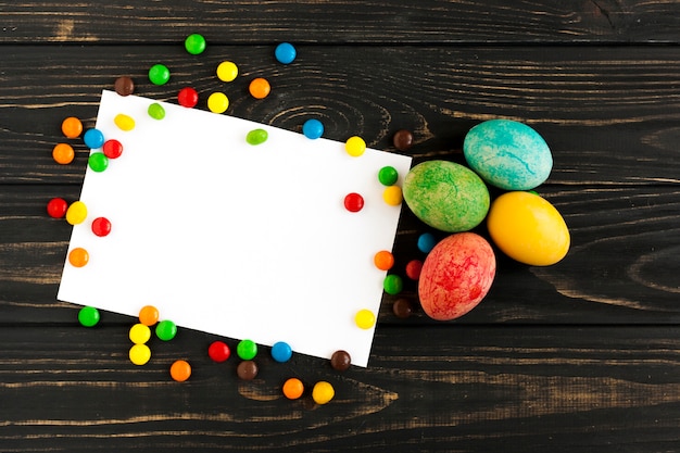 Sweets and four eggs near paper