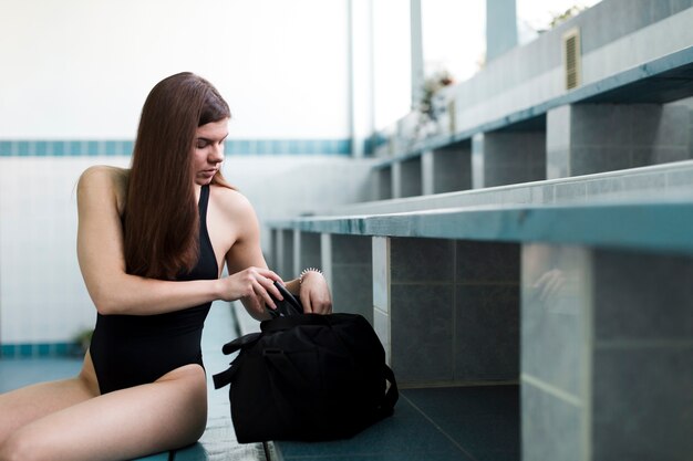 Swimmer checking sports bag front view