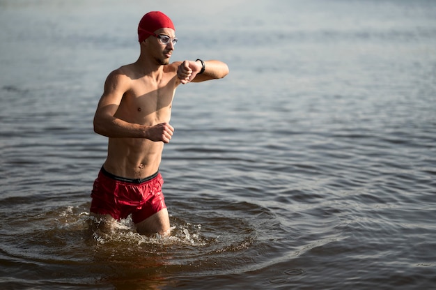 Swimmer walking in lake