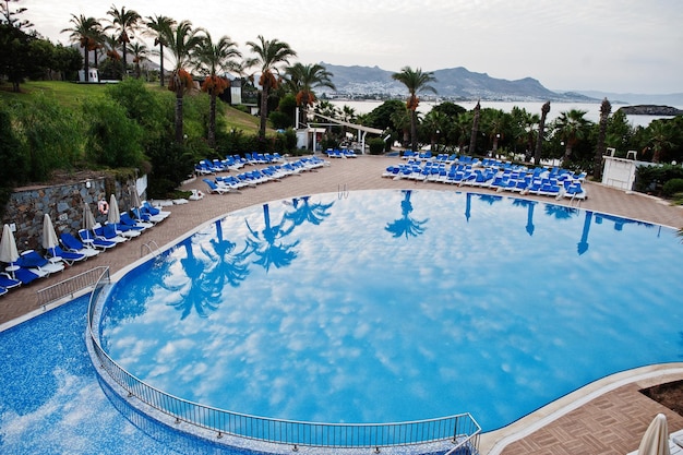 Swimming pool in morning at mediterranean summer resort hotel in Turkey Bodrum Reflection in water