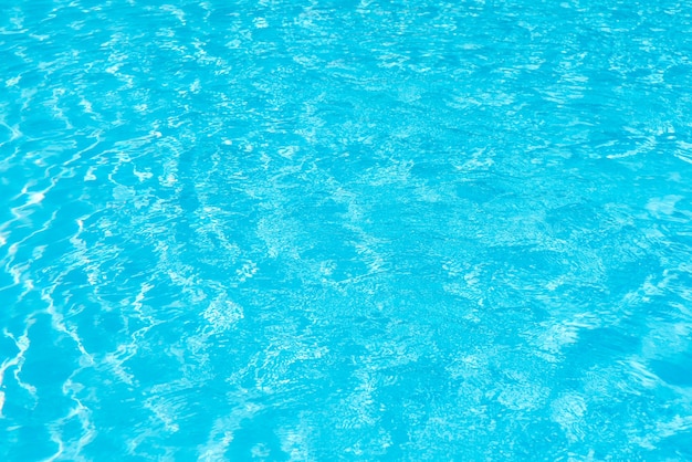 Swimming pool water surface with sparkling light reflections