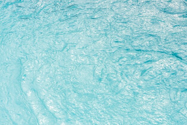 Swimming pool water texture in sunlight background