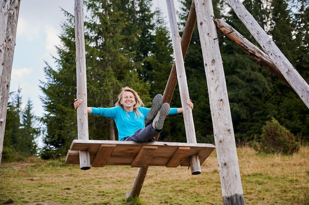 Free photo swinging on giant wooden attraction outdoors at summer