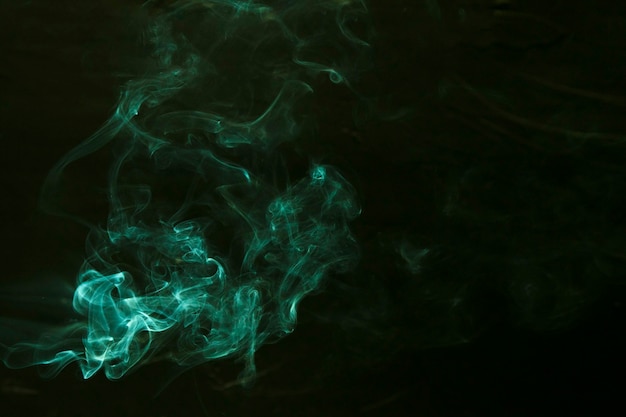 Swirl of green smoke on dark background