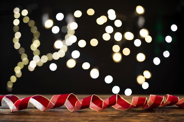 Free photo swirling ribbon near blurred garland