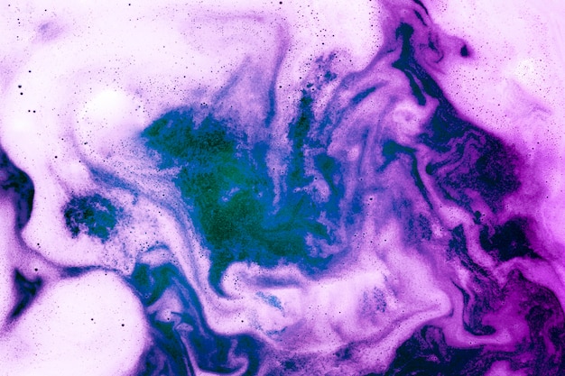 Free photo swirls of foam on gradient colored liquid