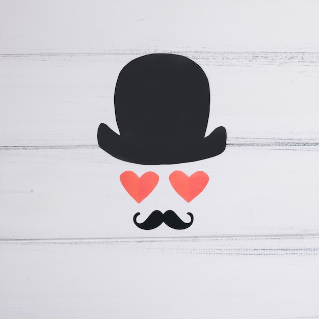 Symbol of man of paper hearts and ornamental mustache