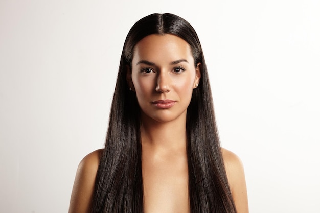 Symmetric portrait of a beauty woman with a stright hair in studio