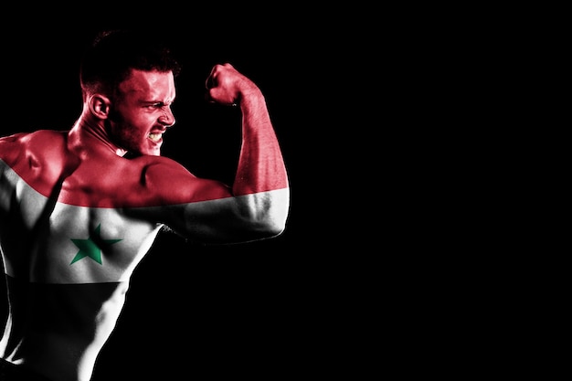 Syria flag on handsome young muscular man black background