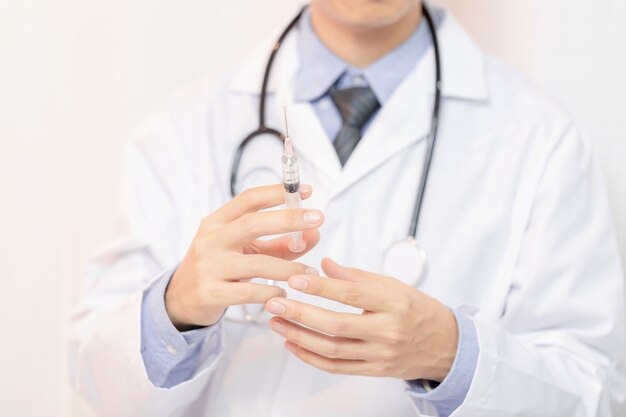 Syringe, medical injection in hand, palm or fingers. 