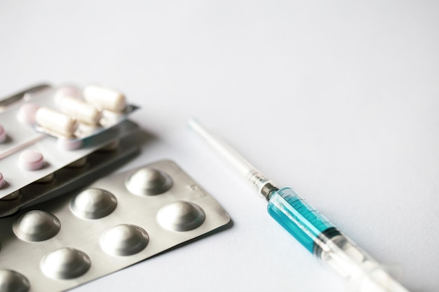 Free photo syringe and pills on a white background isolated closeup