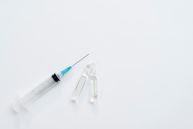 Syringe and vial on white background