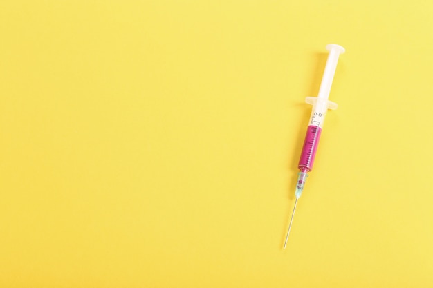 Syringe with pink liquid