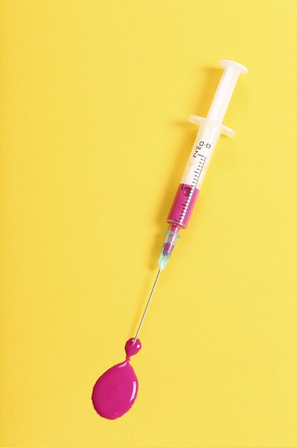 Syringe with pink liquid