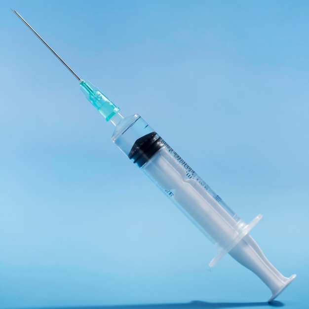 Syringe with vaccine on close-up