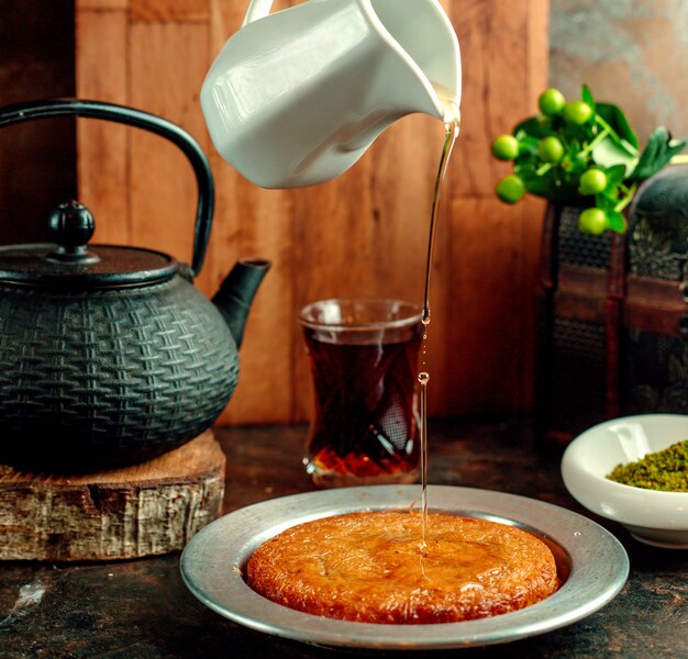 Syrup poured onto kunefe dessert