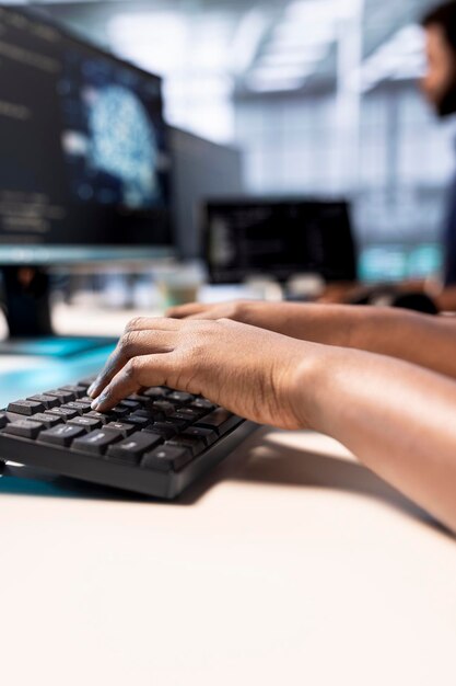system administrator in server farm using ai systems typing on keyboard