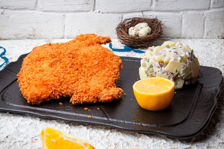 Free Photo tabaka in batter with olivier salad and lemon and quail eggs in tray