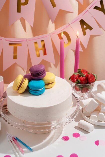 Free photo table arrangement for birthday event with cake and macaroons