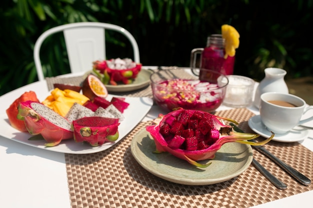 Free photo table arrangement with dragon fruit snacks outdoors