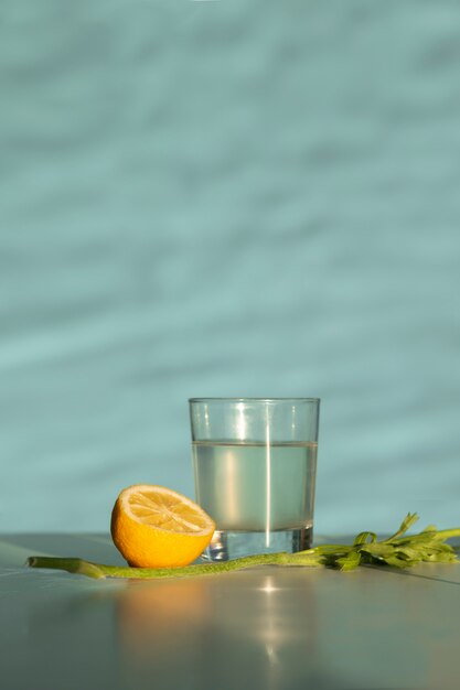 Table arrangement with lemon half and water glass